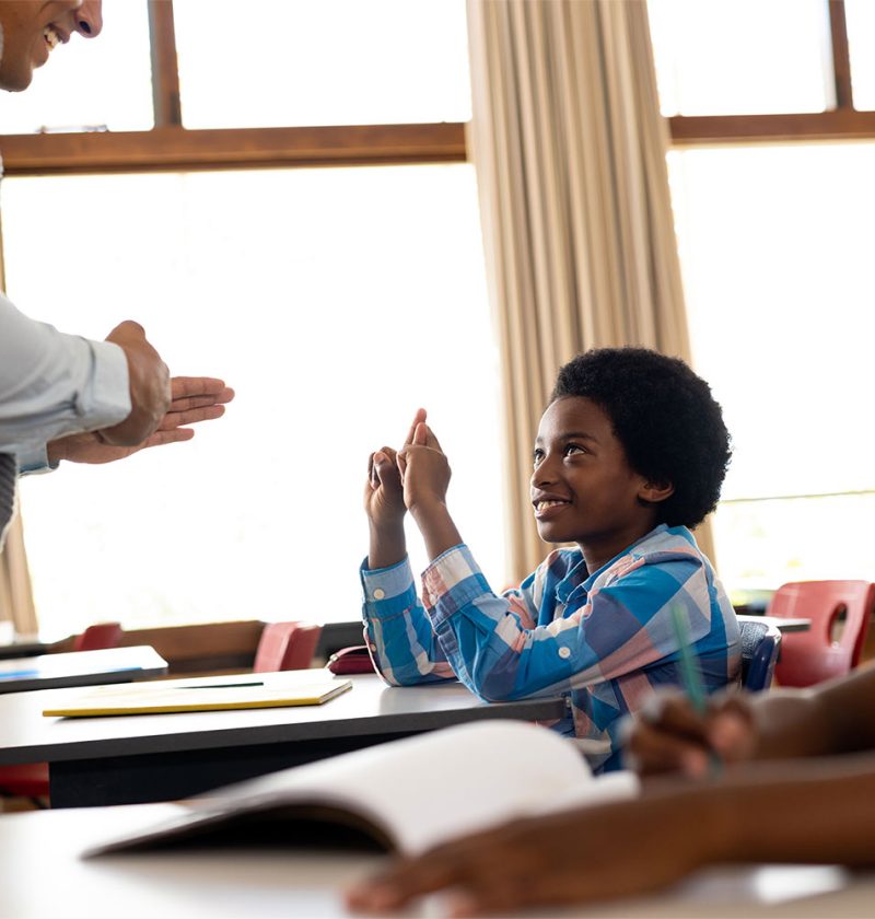 diverse-male-teacher-teaching-school-boy-using-sig-2025-04-04-05-05-39-utc